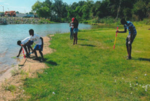 group of people cleaning the river